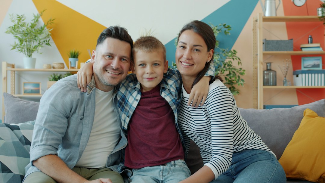 A happy family of three posing for a photo