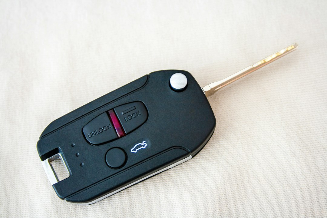 A black car key fob with unlock, lock, and trunk release buttons